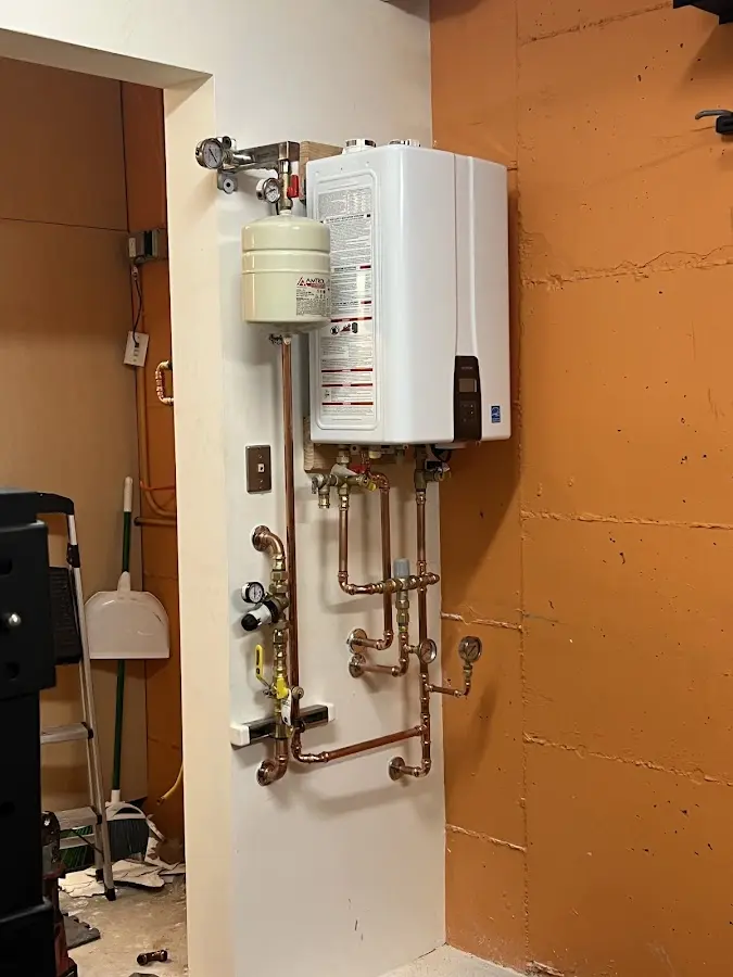 Plumbing technician inspecting water heater connections in Port Aransas